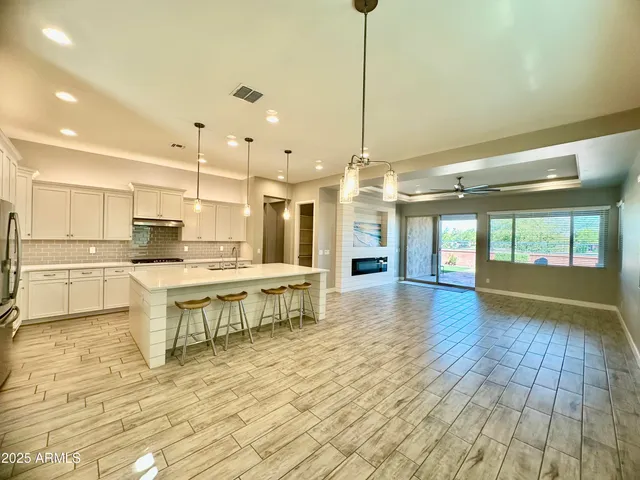 a open kitchen with stainless steel appliances granite countertop a stove and refrigerator