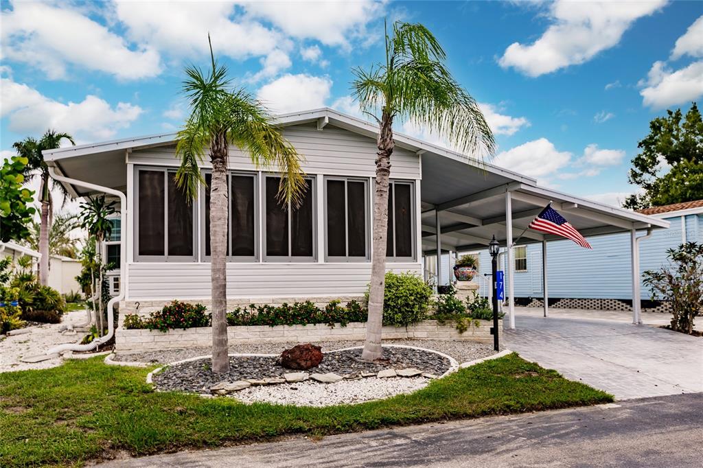 15550 Burnt Store Road, Unit 174 Punta Gorda, FL 33955 - Photo 1 of 1 Front of home lanai, carport and shed