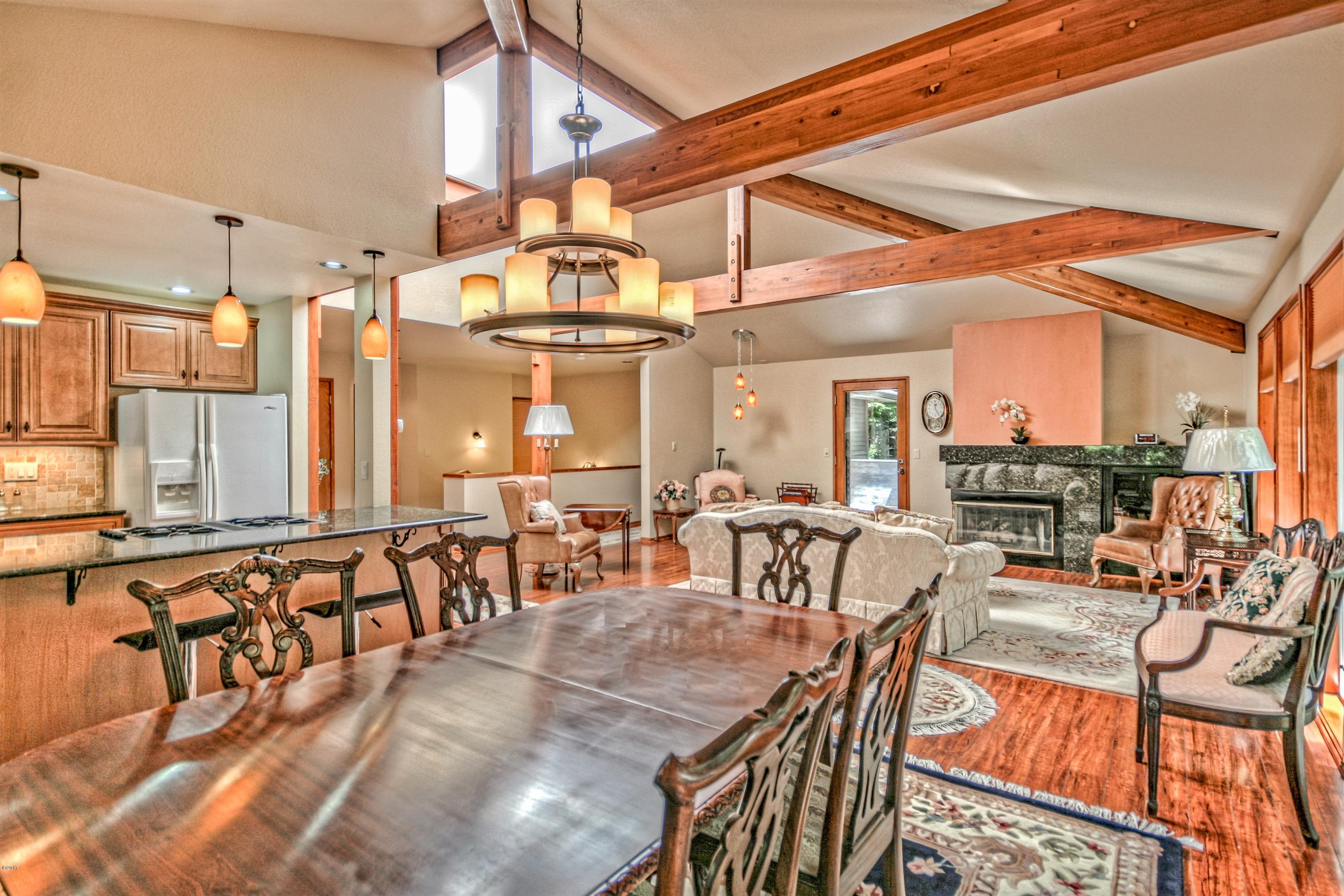 17 Big Tree Road Gleneden Beach, OR 97388 - Photo 15 of 52 a view of a patio with dining table and chairs