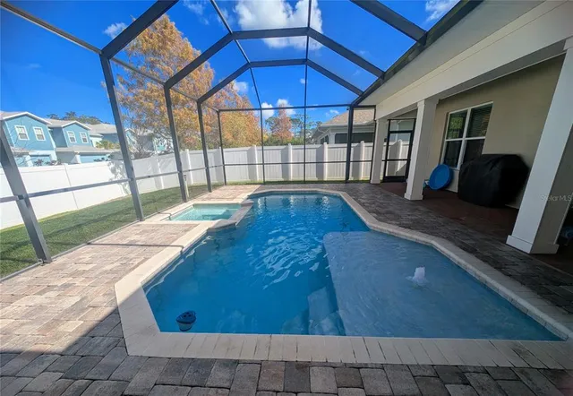 a bedroom with a bed flat screen tv and a window