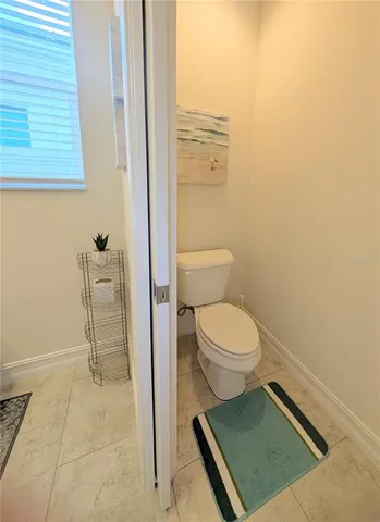 a bedroom with a bed and a flat tv screen on dresser