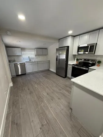 a kitchen with stainless steel appliances a refrigerator and a stove top oven