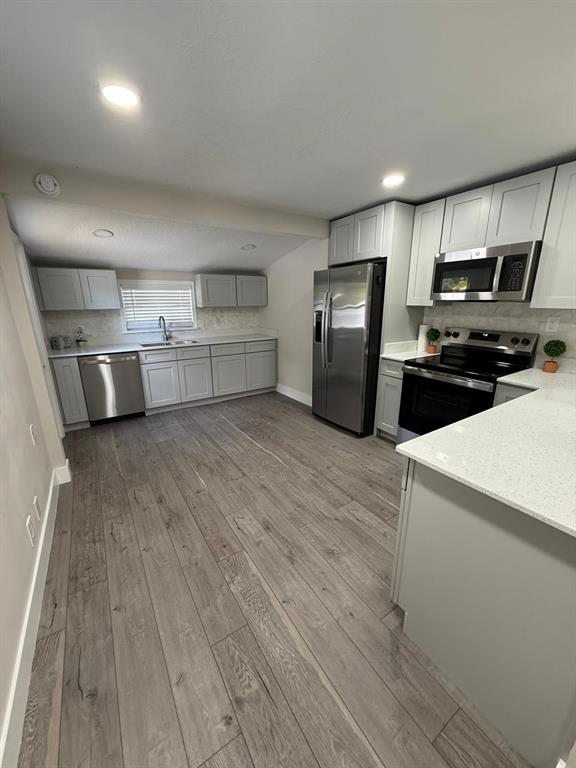 721 Magnolia Street Windermere, FL 34786 - Photo 3 of 13 a kitchen with stainless steel appliances a refrigerator and a stove top oven