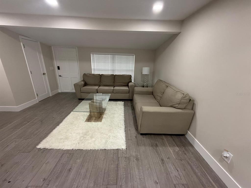 721 Magnolia Street Windermere, FL 34786 - Photo 10 of 13 a living room with furniture and a wooden floor