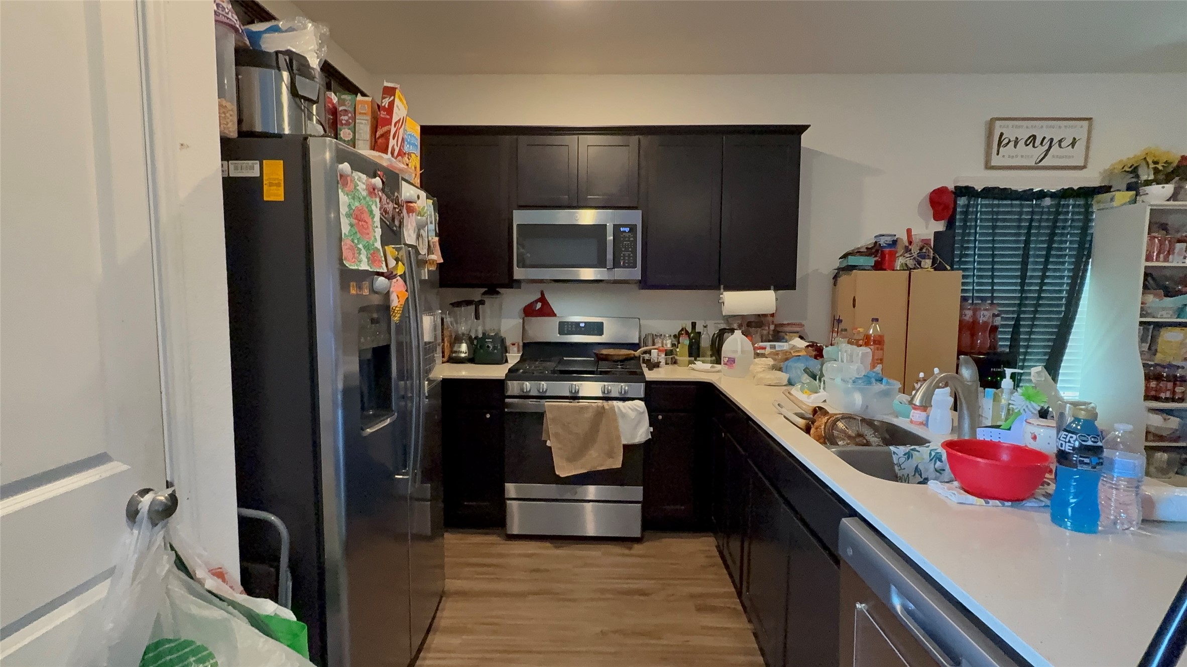 316 Geode Glen Maxwell, TX 78656 - Photo 8 of 24 a kitchen with a sink cabinets and stainless steel appliances