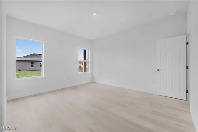 a spacious bathroom with double sink and mirror