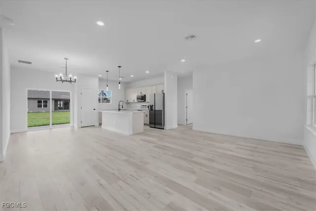 a view of a kitchen with a sink and a stove top oven