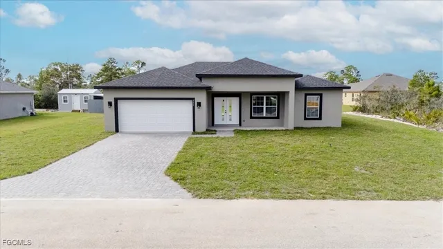 an aerial view of residential houses with outdoor space and swimming pool