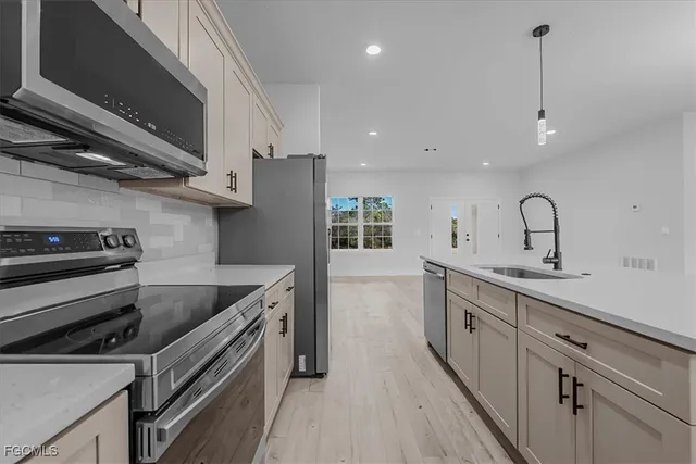 a kitchen with a sink stove and cabinets