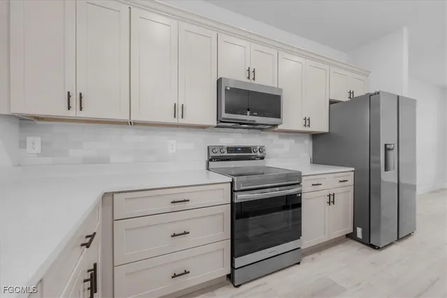 a view of a kitchen with wooden floor and a kitchen