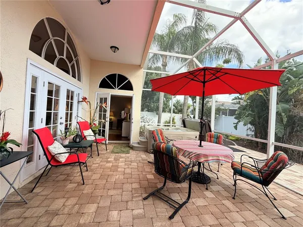 a view of a patio with table and chairs under an umbrella