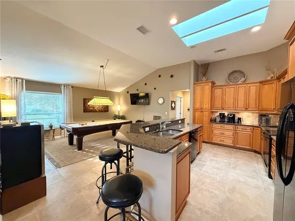 a kitchen with stainless steel appliances granite countertop a stove and a refrigerator