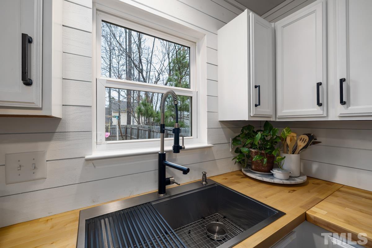 1205 Lombar Street Raleigh, NC 27610 - Photo 12 of 31 a kitchen with a sink and a window