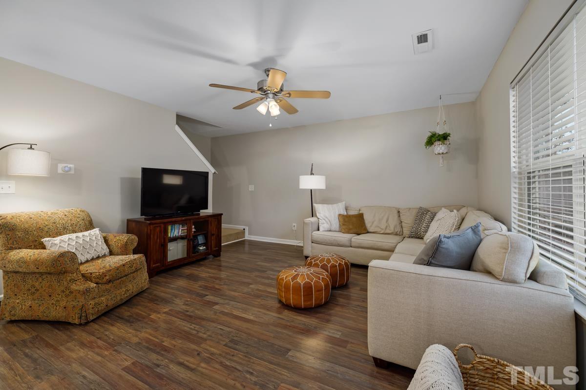 1205 Lombar Street Raleigh, NC 27610 - Photo 15 of 31 a living room with furniture a flat screen tv and a couch