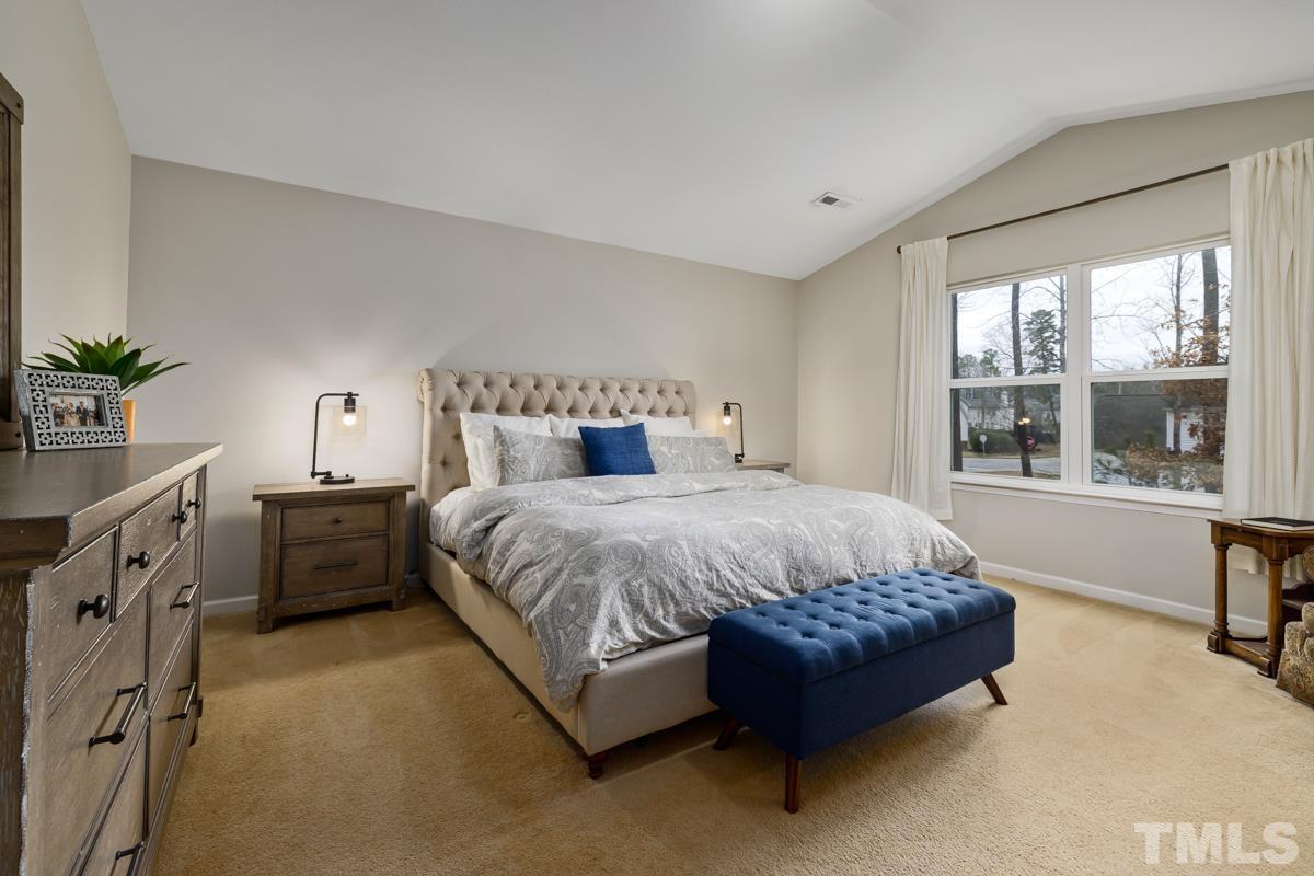 1205 Lombar Street Raleigh, NC 27610 - Photo 17 of 31 a spacious bedroom with a large bed and a window