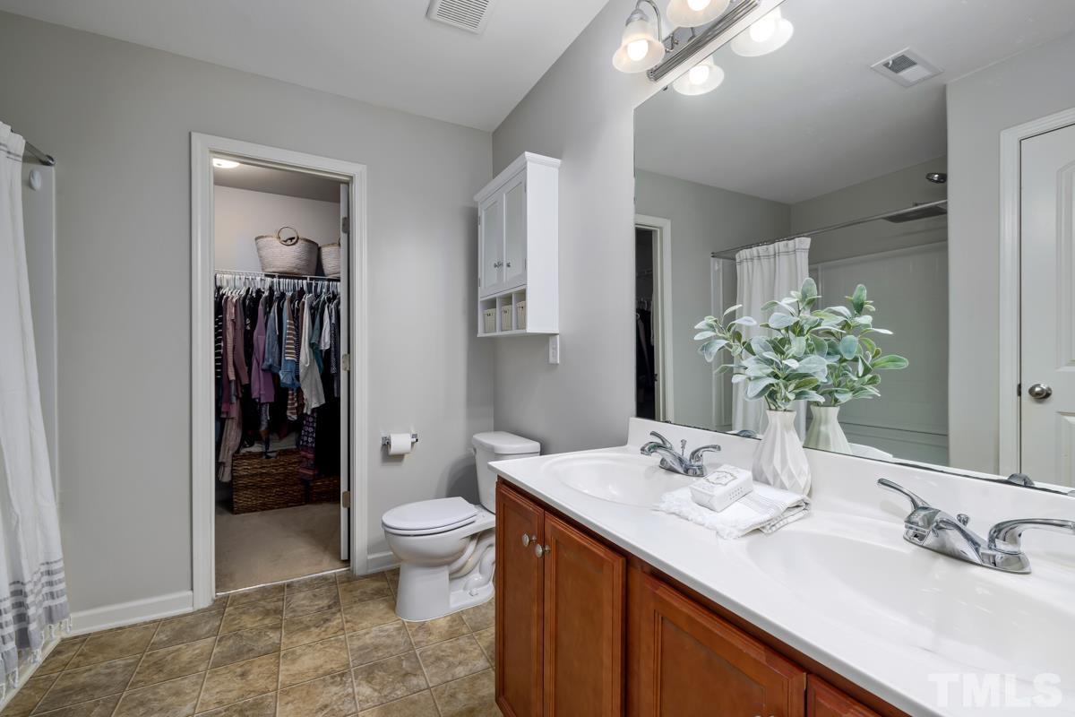 1205 Lombar Street Raleigh, NC 27610 - Photo 21 of 31 a bathroom with a sink a toilet and shower
