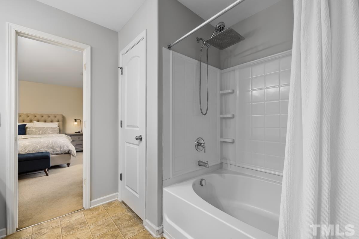 1205 Lombar Street Raleigh, NC 27610 - Photo 22 of 31 a bathroom with a tub and a shower