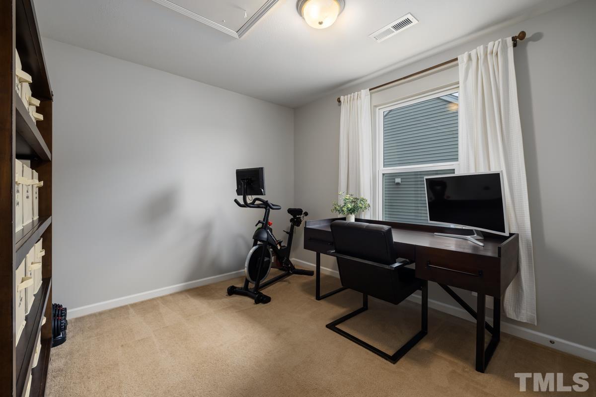 1205 Lombar Street Raleigh, NC 27610 - Photo 24 of 31 a view of a workspace with furniture and a window