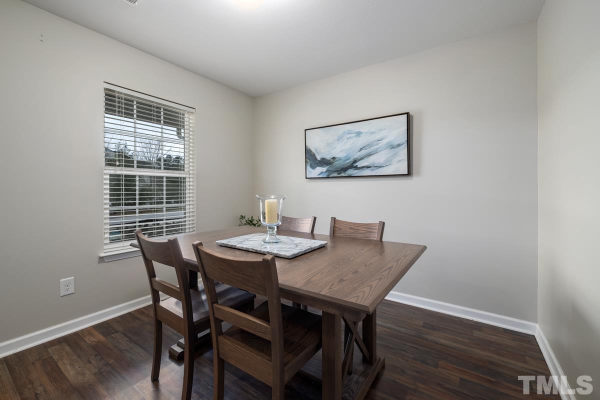 1205 Lombar Street Raleigh, NC 27610 - Photo 8 of 31 a view of a dining room with furniture and wooden floor