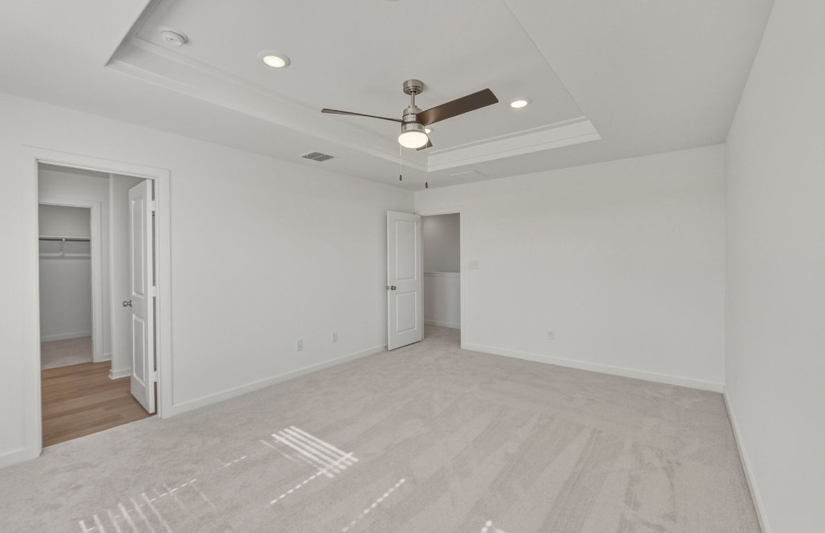 172 Golden Bell Way Buda, TX 78610 - Photo 10 of 24 en empty room with ceiling fan and window