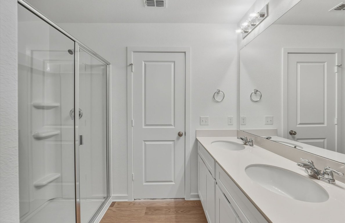 172 Golden Bell Way Buda, TX 78610 - Photo 12 of 24 a bathroom with 2 sink and a mirror