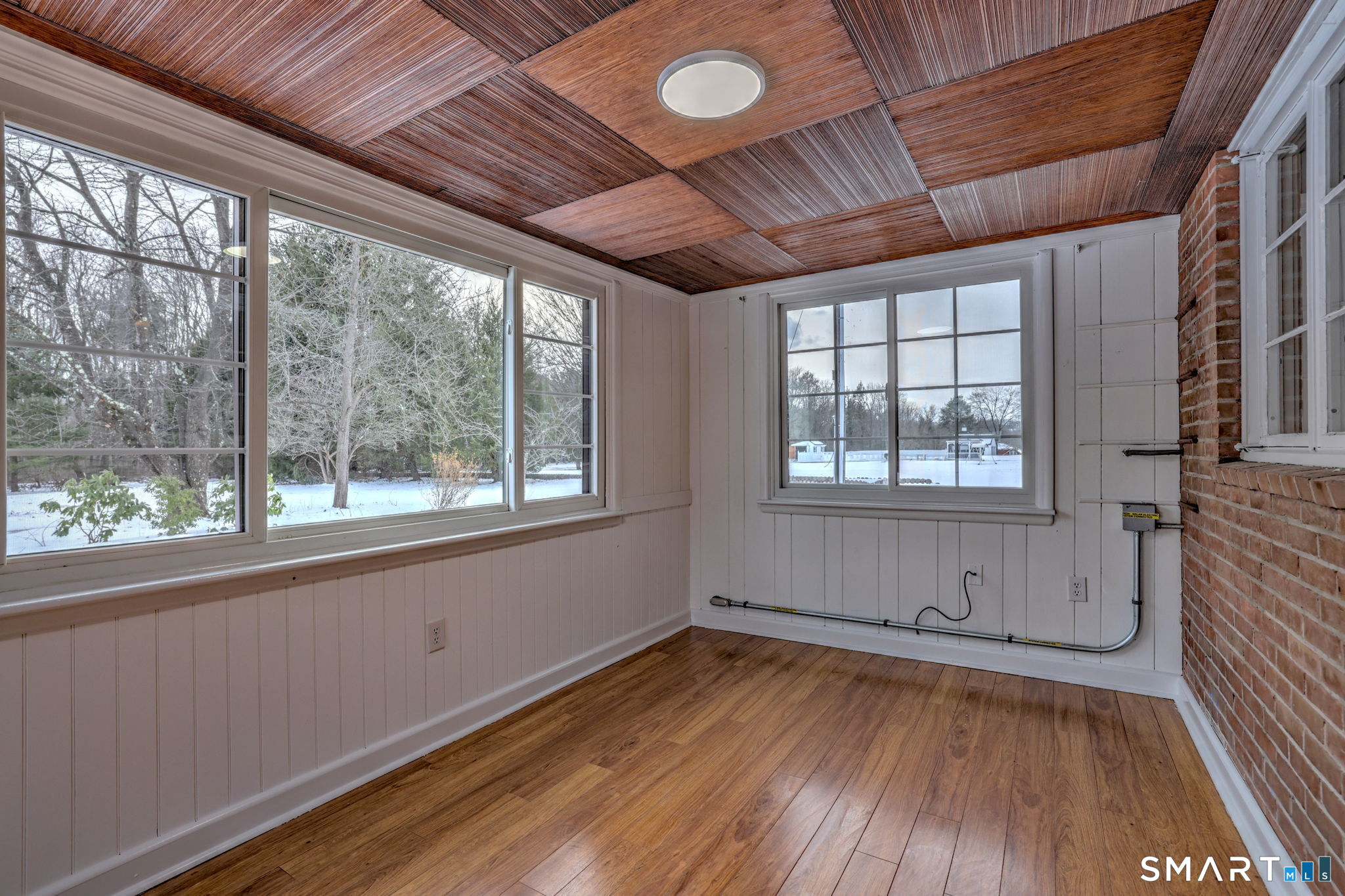 53 Geer Street Cromwell, CT 06416 - Photo 23 of 40 an empty room with wooden floor and windows