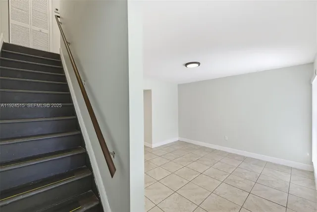 a bathroom with a granite countertop bathtub shower sink vanity and toilet