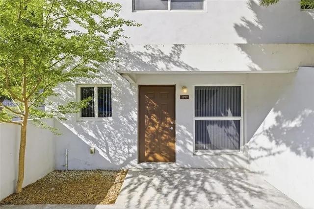 a view of a house with a tree in front
