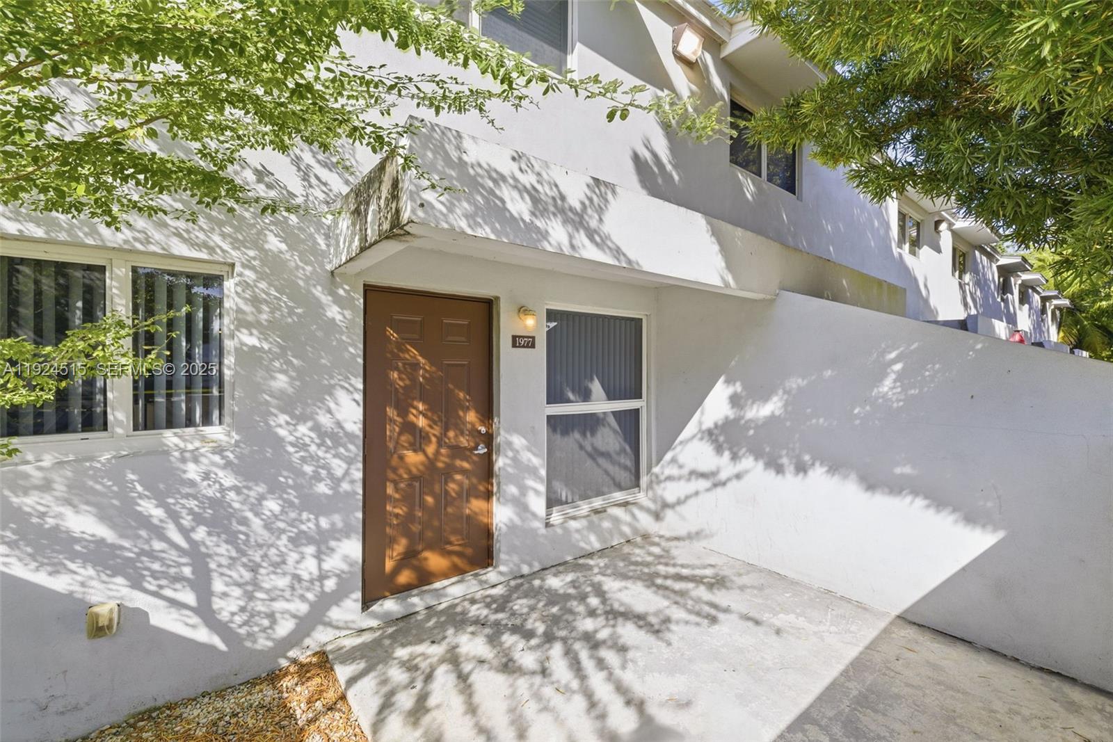 1977 Northwest 5th Place, Unit 408 Miami, FL 33136 - Photo 20 of 25 a view of a house with a tree in front