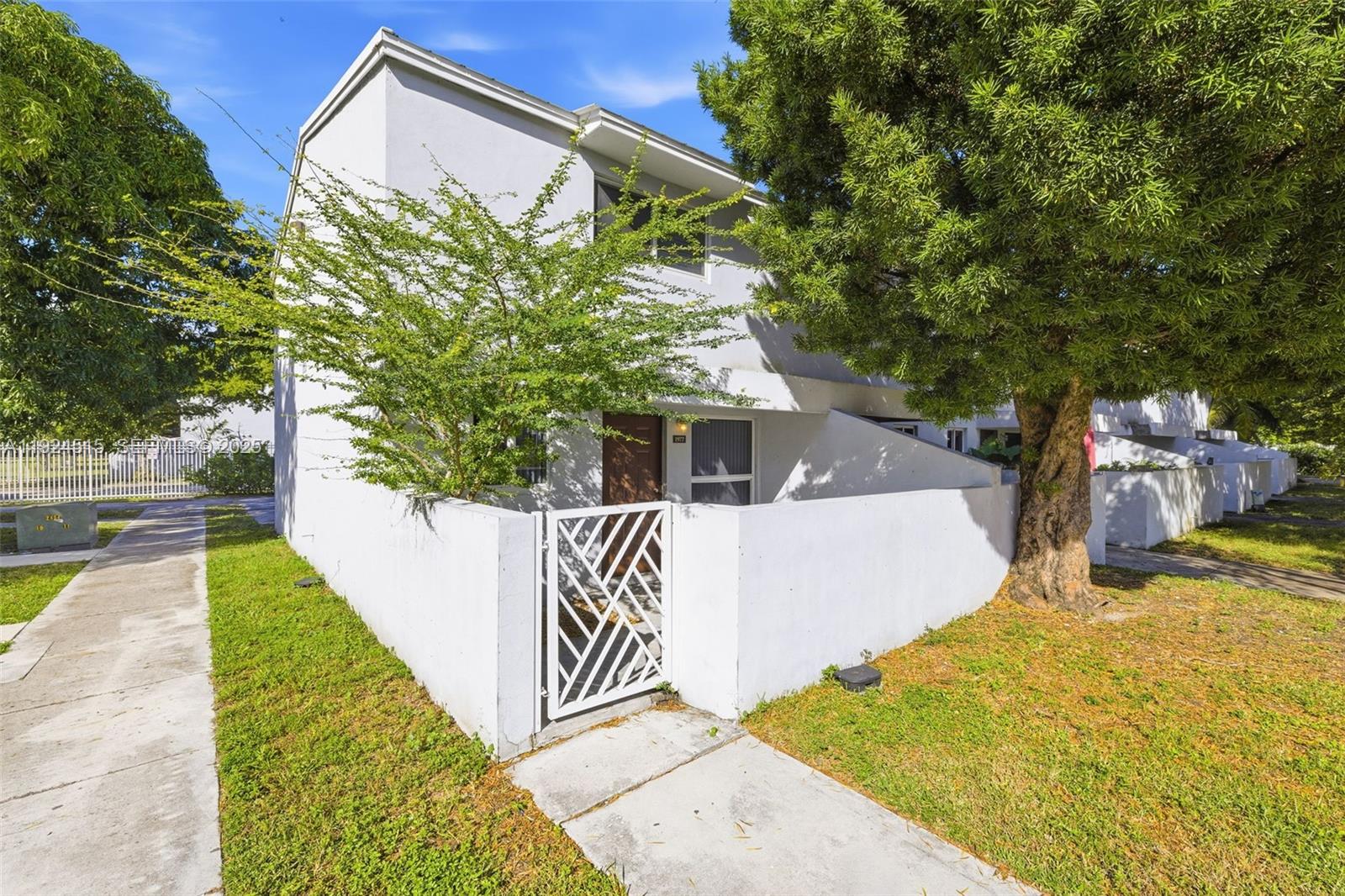 1977 Northwest 5th Place, Unit 408 Miami, FL 33136 - Photo 24 of 25 a front view of a house with a yard and garage