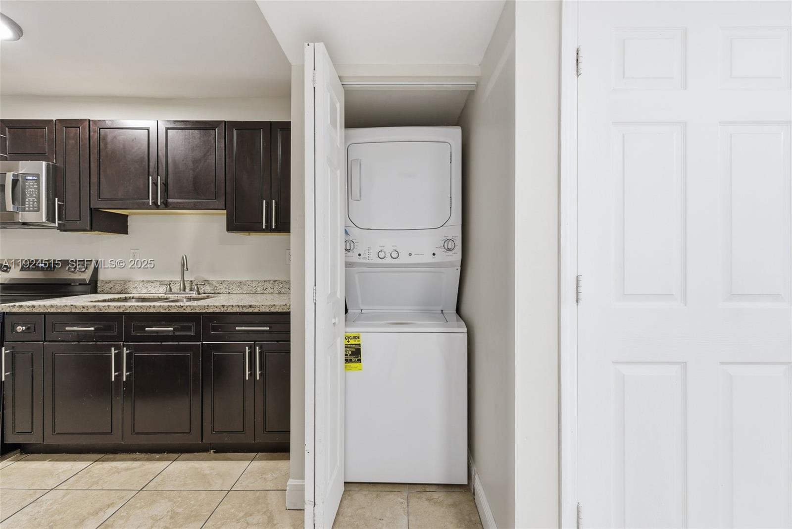 1977 Northwest 5th Place, Unit 408 Miami, FL 33136 - Photo 3 of 25 a kitchen with a sink and a stove