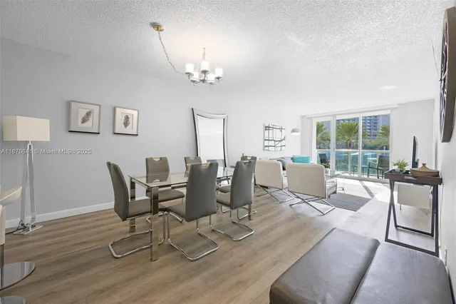 a living room with furniture a dining table and a bookshelf