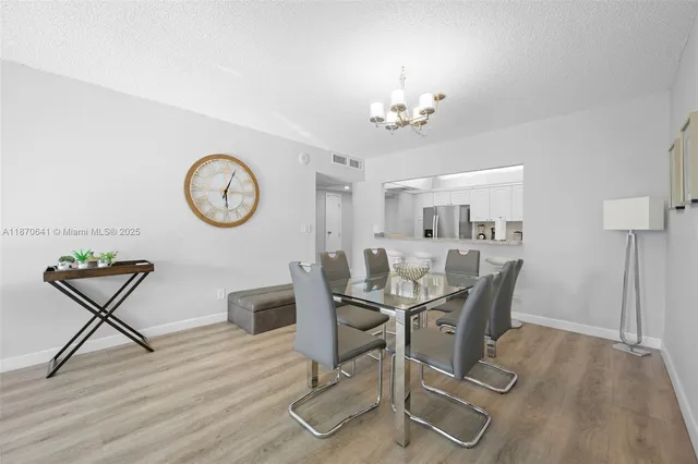 a view of a dining room with furniture and a chandelier