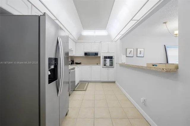a kitchen with stainless steel appliances a refrigerator and a stove top oven
