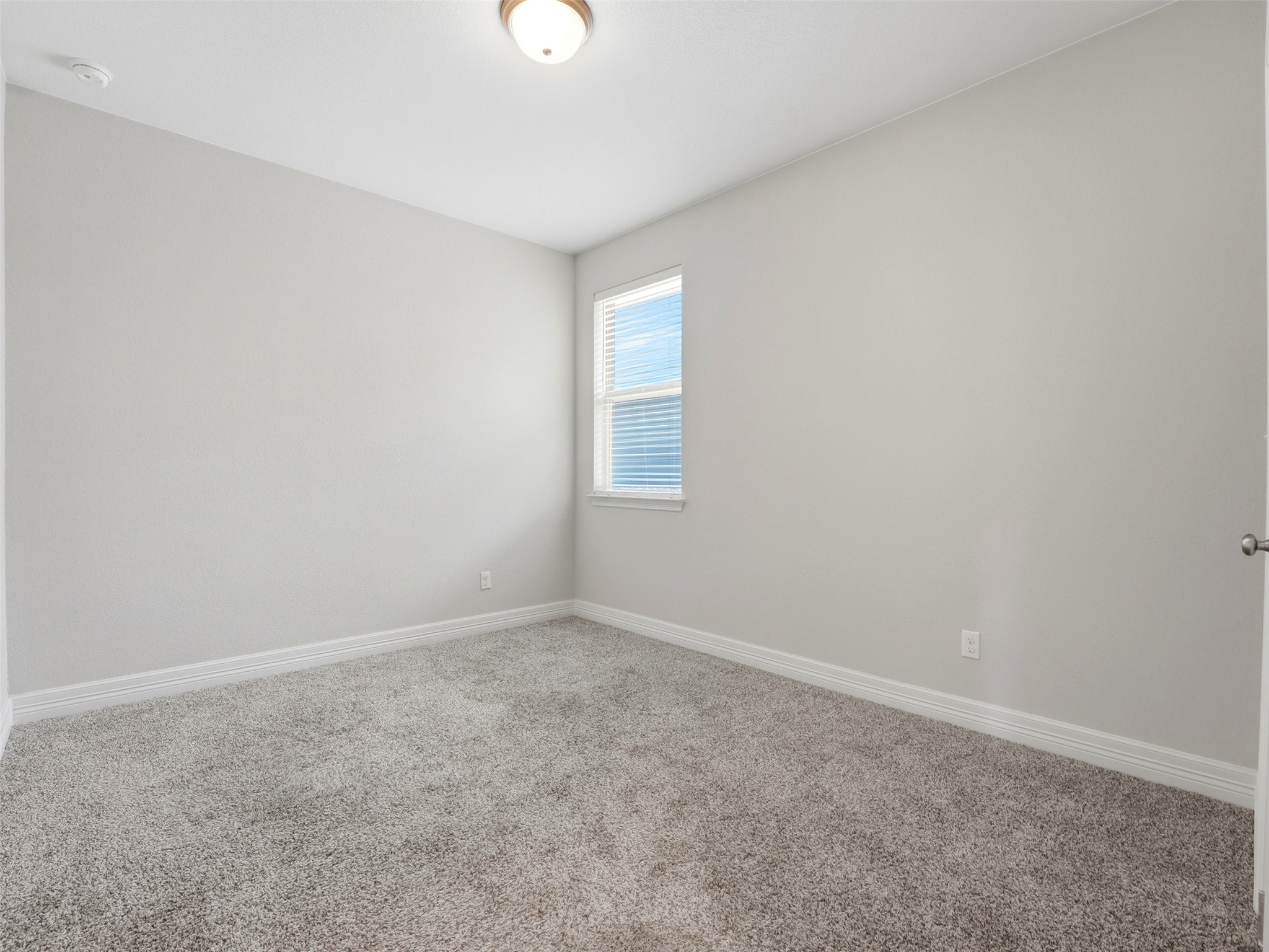 2132 Ringstaff Road Leander, TX 78641 - Photo 30 of 39 A neutral, inviting space awaits personalization, offering quiet repose and soft, carpeted comfort.