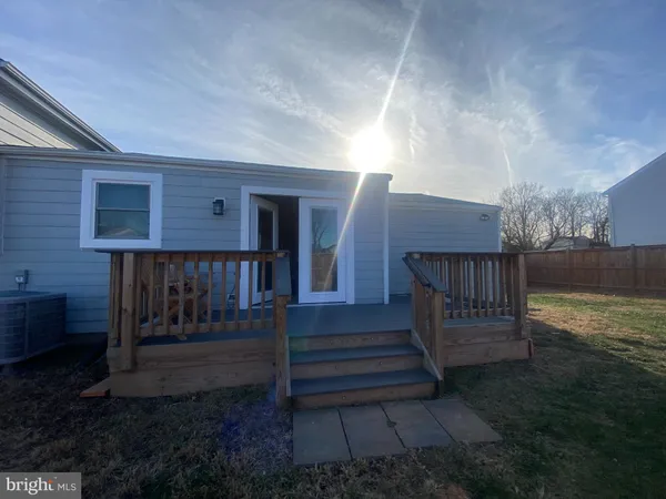 a view of a yard with wooden fence