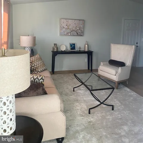 a living room with furniture and a lamp