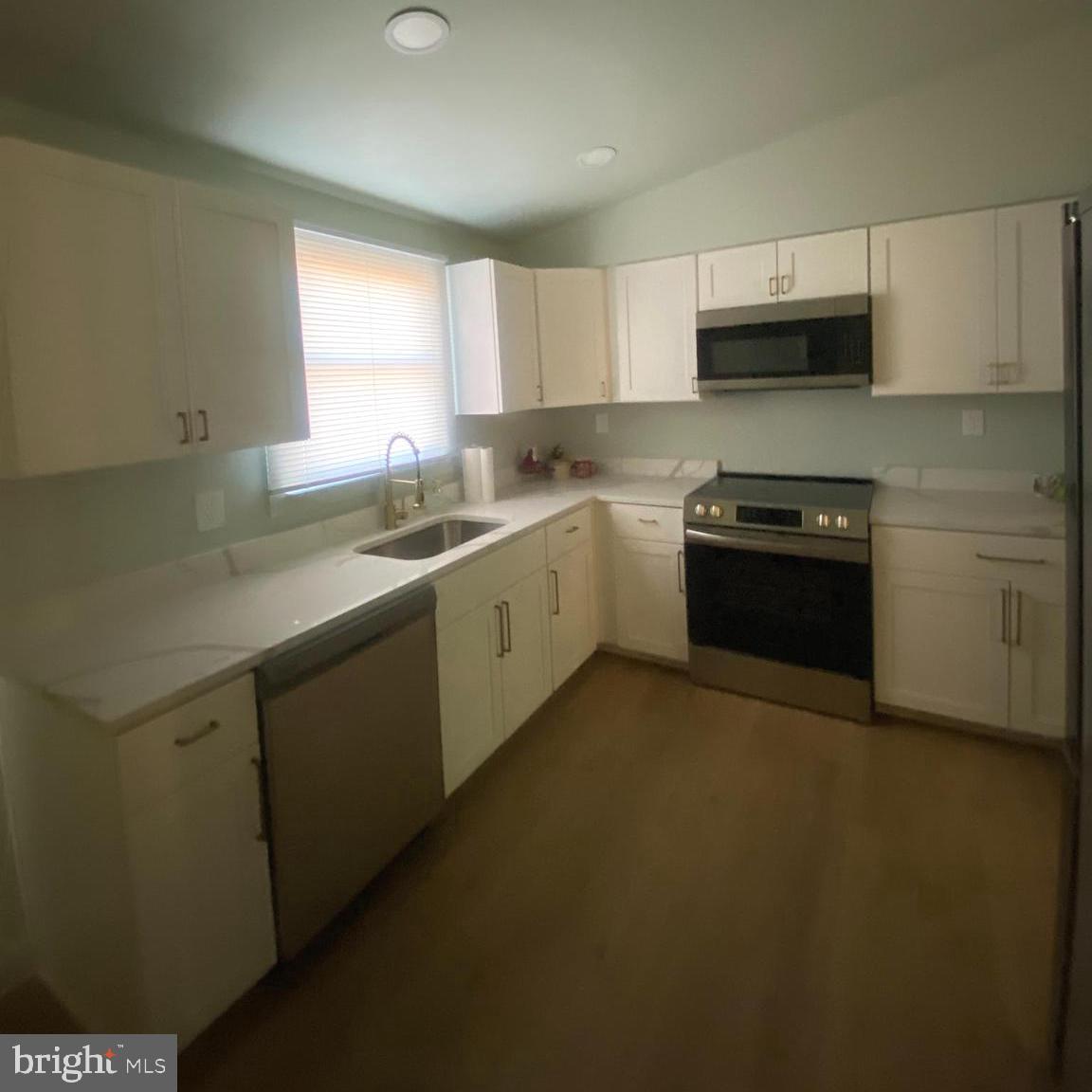 4426 Cub Run Road Chantilly, VA 20151 - Photo 6 of 20 a kitchen with stainless steel appliances granite countertop a sink stove and microwave