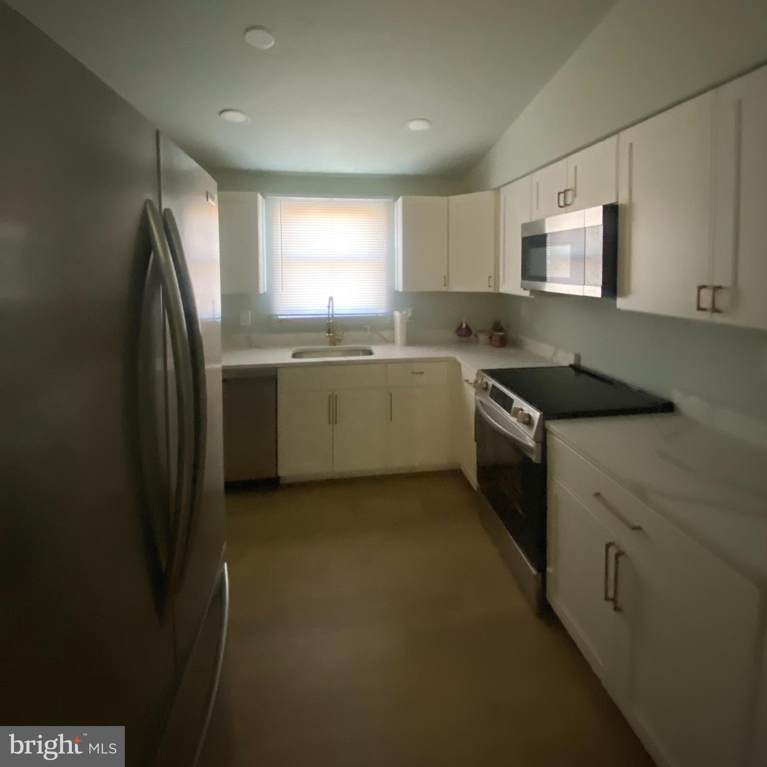 4426 Cub Run Road Chantilly, VA 20151 - Photo 7 of 20 a kitchen with a sink stove and cabinets