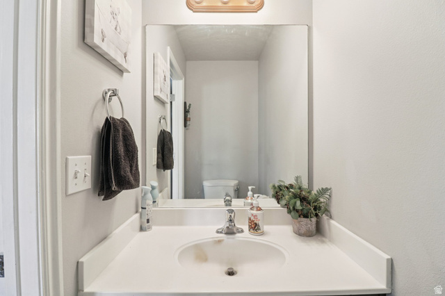 1077 South 1850th Street West Springville, UT 84663 - Photo 11 of 22 Half bathroom with toilet and vanity