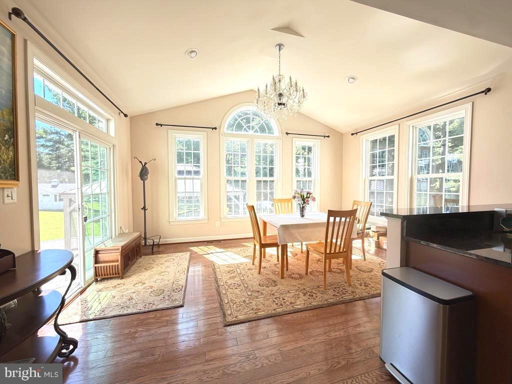 9804 Anvil Court Perry Hall, MD 21128 - Photo 8 of 21 a view of a dining room with furniture large windows and wooden floor