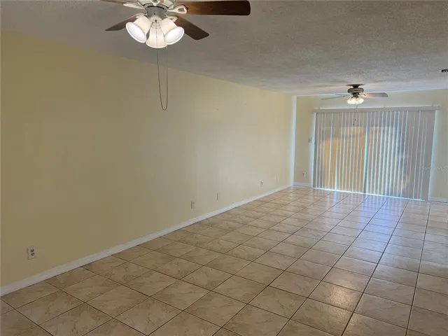 a view of a livingroom with a chandelier fan