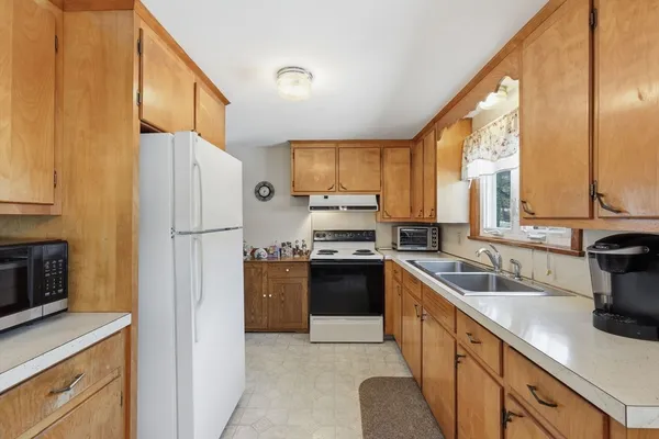 a kitchen with a refrigerator a sink and cabinets