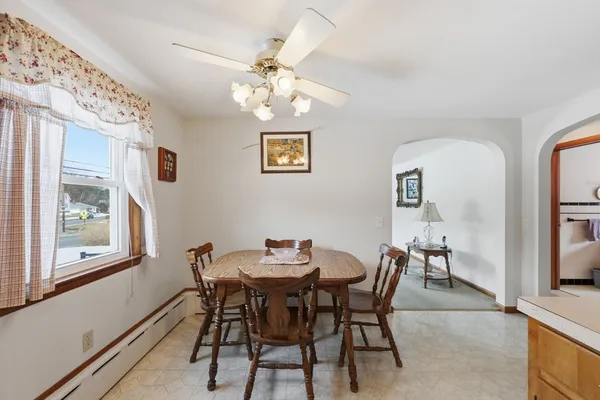 a view of a dining room with furniture and chandelier