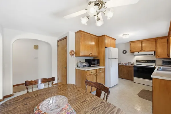 a kitchen with stainless steel appliances granite countertop a stove refrigerator and a sink