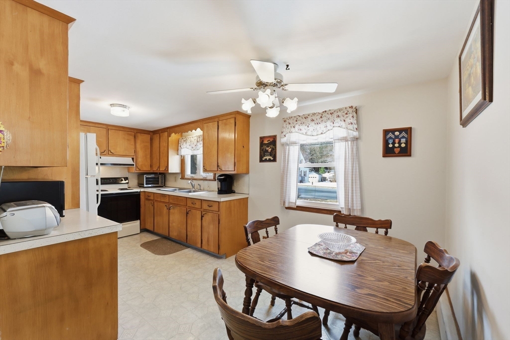 4452 High Street Palmer, MA 01069 - Photo 18 of 41 a view of a dining room with furniture and a chandelier