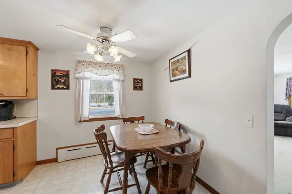 a view of a dining room with furniture and chandelier