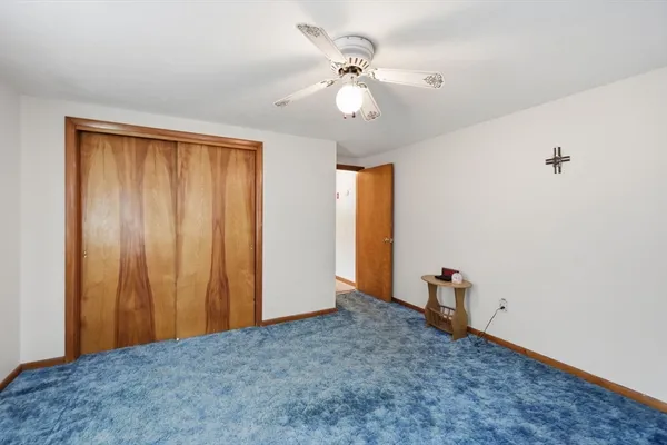 a view of an empty room with a fan