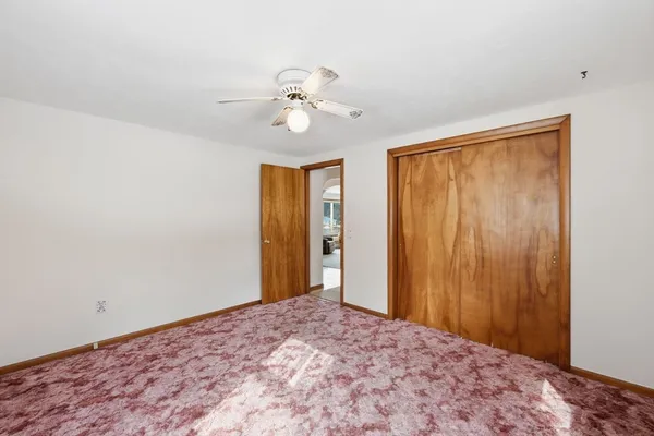 a view of a hallway with a chandelier fan