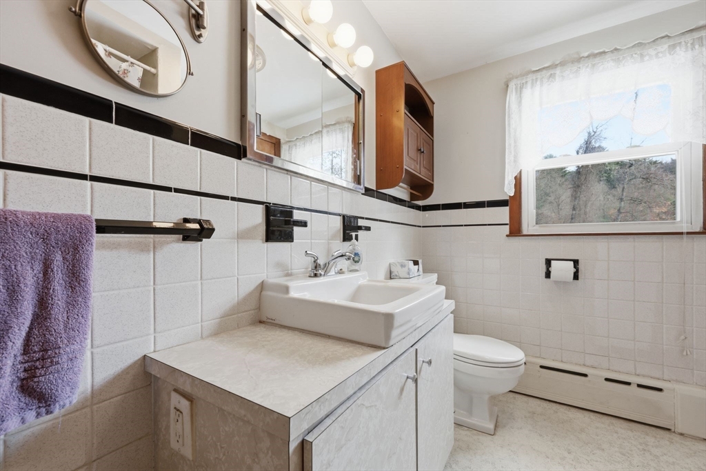 4452 High Street Palmer, MA 01069 - Photo 29 of 41 a bathroom with a sink a toilet and mirror